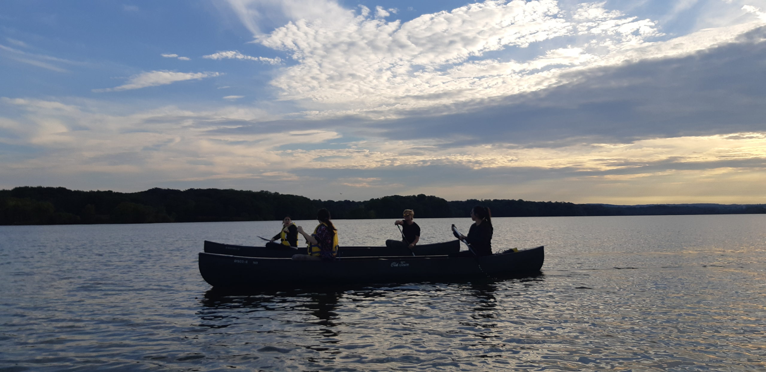 Four people in two canoes touring Cootes Paradise as part of the Bay Area Restoration Council's volunteer program: Community Water Leaders