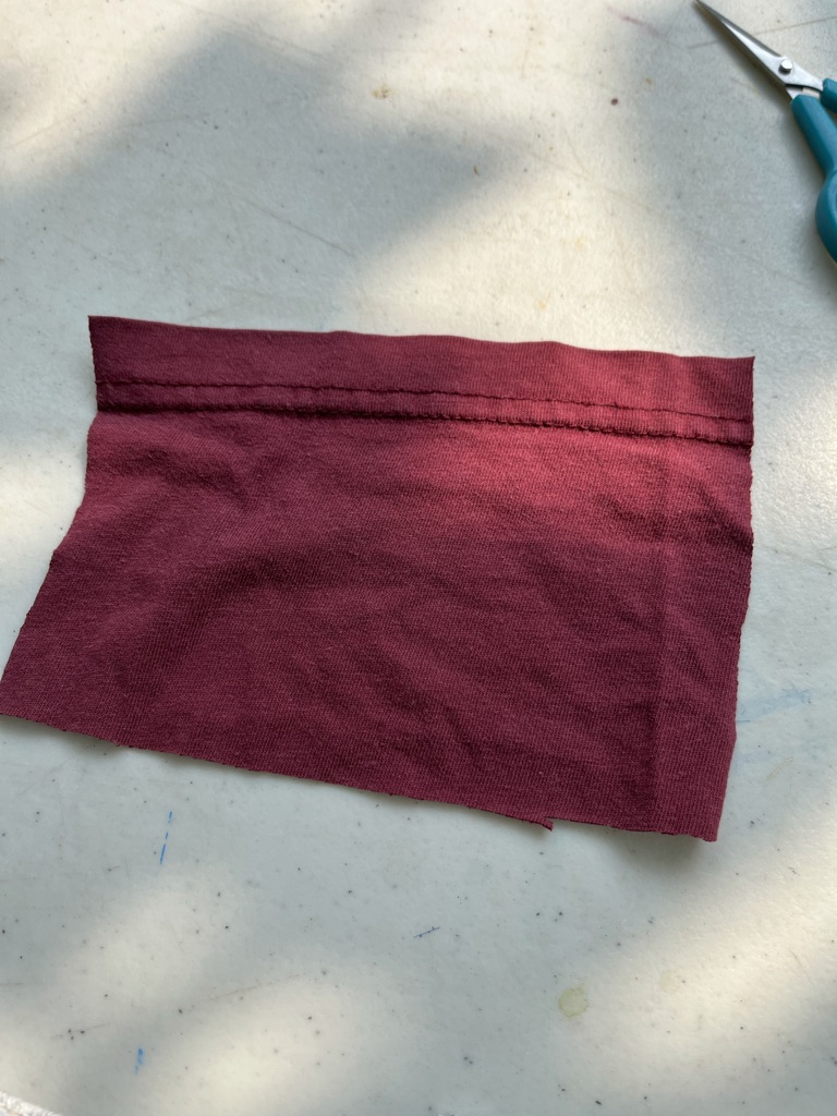 [ID: Rectangle of red fabric]