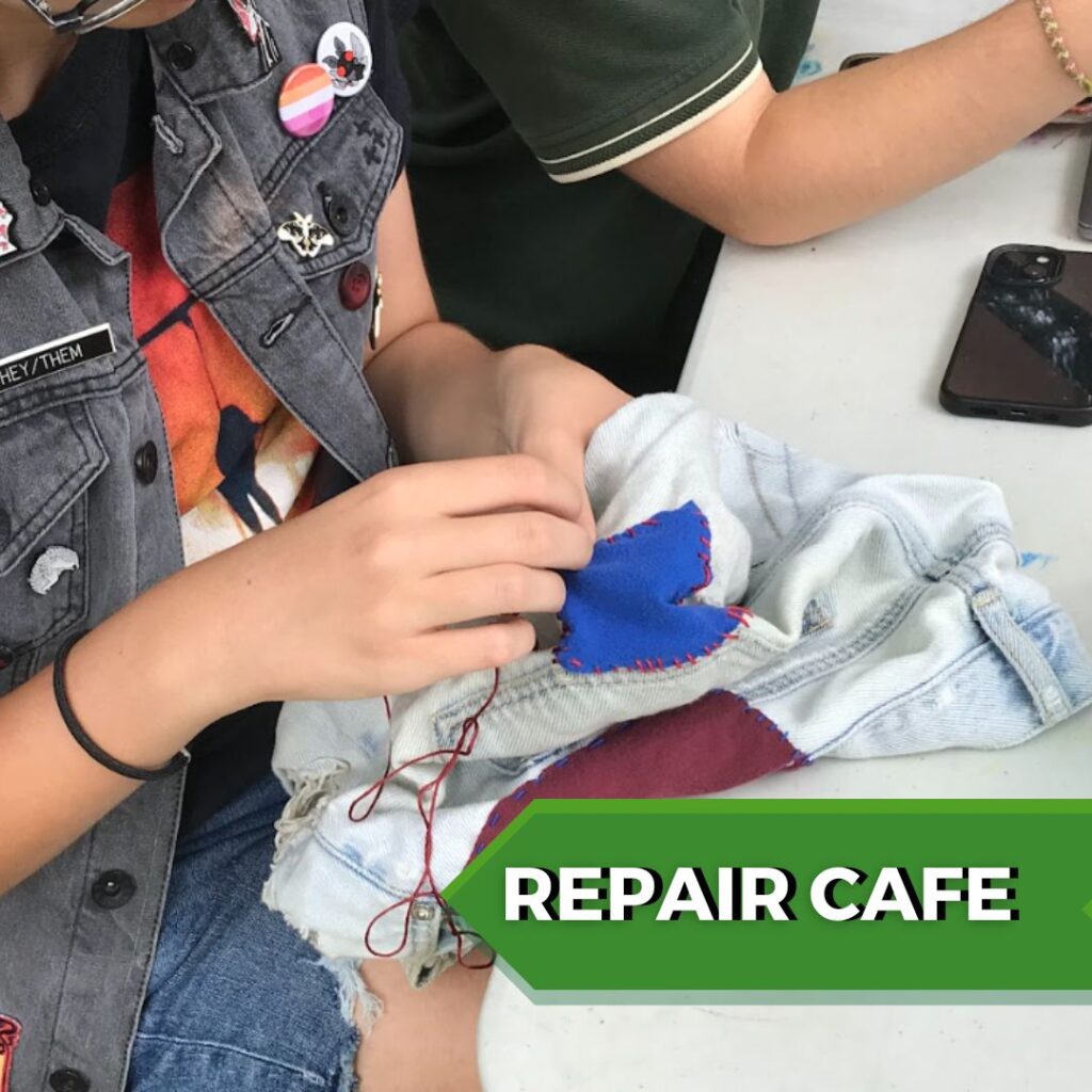 A closeup of hands mending a patch on a pair of jeans and text reads, "repair cafe"
